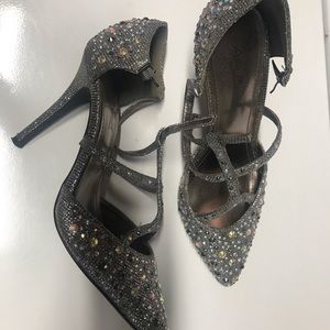 New shoes, silver with straps in the front.